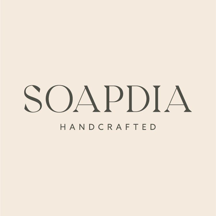 The Soapdia Handcrafted logo, featuring warm beige tones, which illustrates the brand's story: clean thoroughly, live brightly.
