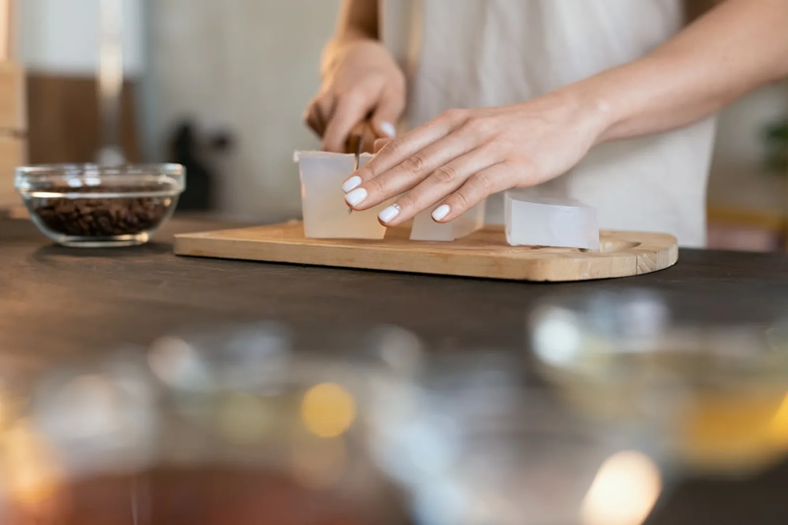 A Soapdia artisan cutting a fresh batch of soap by hand, illustrating the care and craftsmanship in every bar